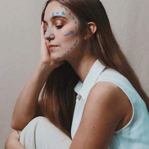 woman in white sleeveless shirt with blue eyes